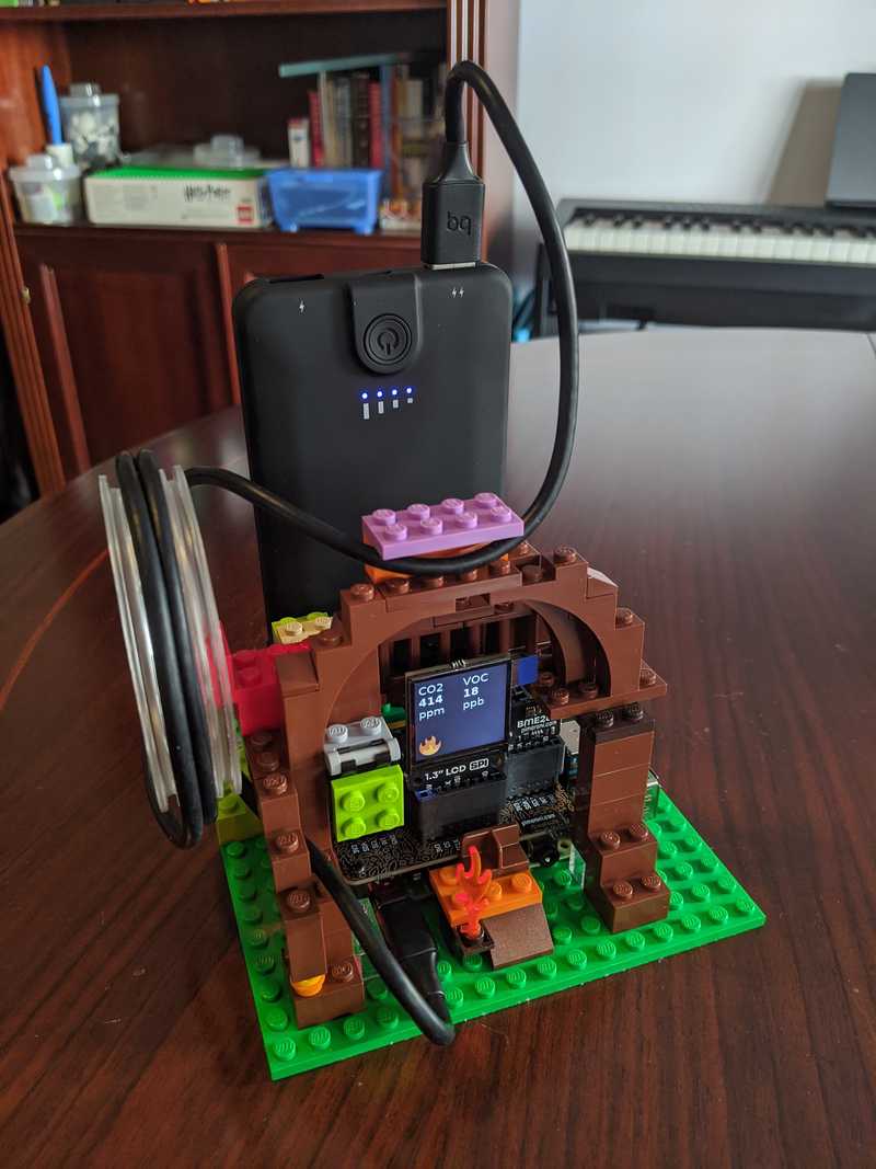 Aparatito hecho con Raspberry Pi y piezas de LEGO. En la pantalla se ven los valores de los sensores de calidad del aire y una llamita. ¡Está vivo!